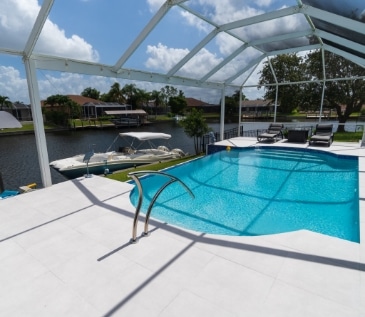 snow white porcelain pavers on a pooldeck created by Accurate Pavers Naples Bonita Springs
